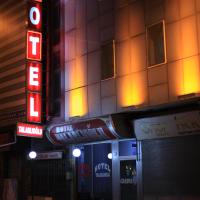 a building with a neon sign in front of it at Talaslioglu Hotel, Kayseri