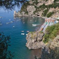 a view of a beach with boats in the water at Hotel Pupetto, Positano