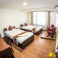 a hotel room with two beds and a chair at Hotel Yambu, Kathmandu