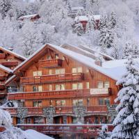 a large wooden building covered in snow at Hotel Le Tremplin, Méribel