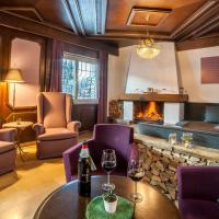 a restaurant with a fireplace and a table and chairs at Boutique Hotel Olympia, Seefeld in Tirol