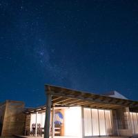 a night view of a building with the stars in the sky at El fortín del Rubio, Cabo Polonio