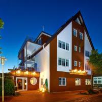 a large brick building with lights on it at night at Bernstein-Hotel Bootshaus, Büsum