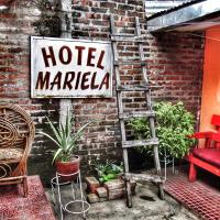 a sign for a hotel marcial market next to a brick wall at Hostal Mariella, Estelí