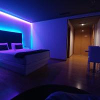 a purple bedroom with a bed and a purple lighting at Motel Trebol, Tui