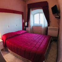 a bedroom with a red bed and a window at Albergo Panorama, Frascati