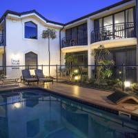 a swimming pool in front of a house at Delorenzo Studio Apartments, Nelson
