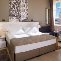 a bedroom with a large bed and a window at Cornaro Hotel, Split