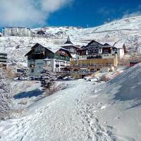 a large building on top of a snow covered mountain at Hotel GHM Monachil, Sierra Nevada