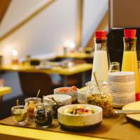 a table with plates of food and bottles of juice at B&B VEADO, Turnhout