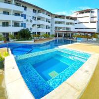 a large swimming pool in front of a building at Hotel Colinas Del Sol, Porlamar