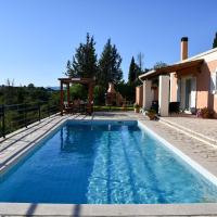 a swimming pool in front of a house at Villa Sophia, Corfu