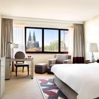 a hotel room with a bed and a desk and a bedroom at Hyatt Regency Köln, Cologne