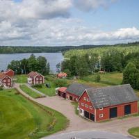 an aerial view of a farm with a house and a lake at Snokebo Gård, Vimmerby