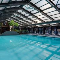 an indoor swimming pool with a glass ceiling and chairs at Hyatt Regency Princeton