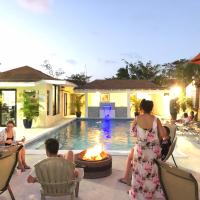 a group of people sitting around a fire pit by a pool at Colony Club Inn & Suites, Nassau