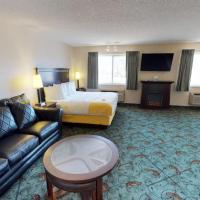 a hotel room with a bed and a couch at Stay Wise Inns of Montrose