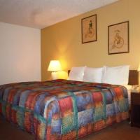 a hotel room with a bed with a colorful blanket at Red Lion Inn & Suites Yakima