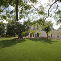 a house with a large yard with green grass at Masseria Torre Catena Resort & Restaurant, Polignano a Mare