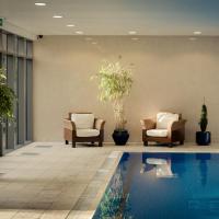 a hotel lobby with a swimming pool and chairs at Rochestown Lodge Hotel, Dun Laoghaire