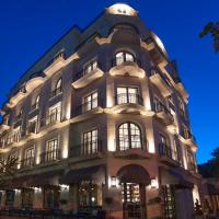 a large white building with windows at night at Hotel Majestic, Budva