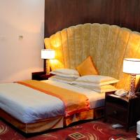 a hotel room with a bed with a large headboard at Kabul Star Hotel & Restaurant, Shīrpūr