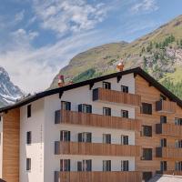 a building with a mountain in the background at Hotel Bristol, Zermatt