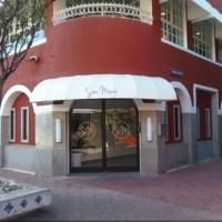 a red building with a white awning in front of a store at San Marco Hotel Curacao & Casino, Willemstad
