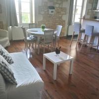 a living room with a couch and a table and chairs at Entre Estuaire et Citadelle, Blaye