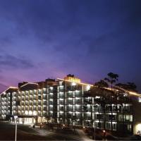 a large building with lights on it at night at Lake Ocean Resort Sokcho