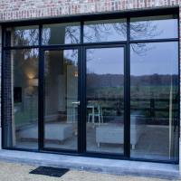 a glass window on a brick building with a patio at B&B De Hessie, Turnhout