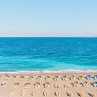 an aerial view of a beach with chairs and the ocean at Hotel Riviera, Rhodes Town