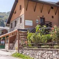 a building with a stone wall next to a street at Apartment Suzana, Mavrovo