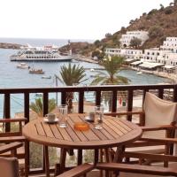 a table on a balcony with a view of the water at Villa Niki, Loutro