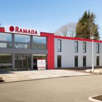 a red and white building with a sign on it at Ramada Chorley South