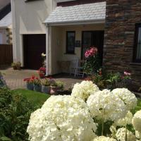 a bunch of white flowers in front of a house at Home from Home B&B, Hartland