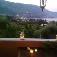 a balcony with candles and a view of the water at Bella Vista, Káto Korakiána