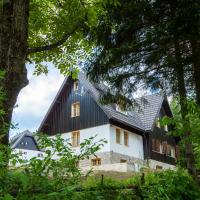 a large white house with a black roof at B&B Plitvica Creek, Plitvica Selo