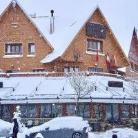 a large building with snow on the roof at L'empreinte D'ifrane, Ifrane