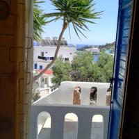 a view of a palm tree from a window at Oasis Hotel Loutro