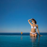 a woman in a bikini sitting in the water at Hotel Napa Suites (Adults Only), Ayia Napa