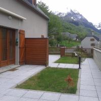 a house with a gate and a yard with mountains at Granges de Trescazes, Loudenvielle