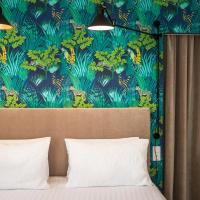 a bedroom with a bed with a blue and green wallpaper at Hotel Edouard VII, Biarritz