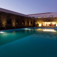 a swimming pool in front of a building at night at Hotel Vila D'Óbidos