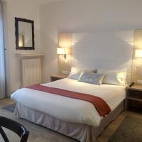 a hotel room with a large bed and a mirror at Hotel Uhainak, Hendaye