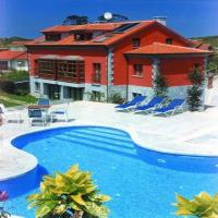 a house with a swimming pool in front of a house at Apartamentos Cueto Mazuga I, Po