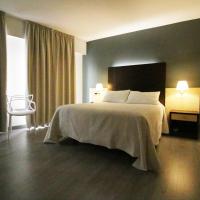 a hotel room with a bed and a chair at Nest Style Santiago, Santiago de Compostela