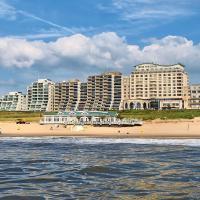 a beach in front of a city with tall buildings at Grand Hotel Huis ter Duin, Noordwijk aan Zee