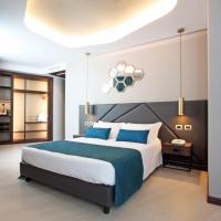 a bedroom with a large bed with blue pillows at The Hive Hotel, Rome
