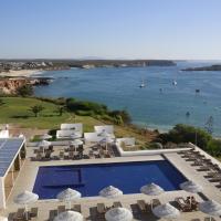 a resort with a swimming pool and a view of the ocean at Memmo Baleeira - Design Hotels, Sagres